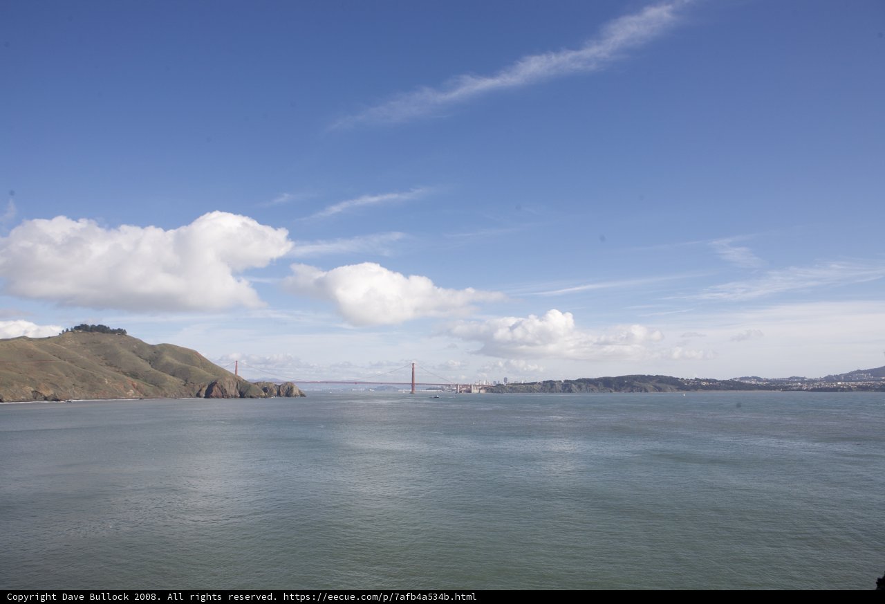 The Golden Gate Bridge shining under the bright blue sky
