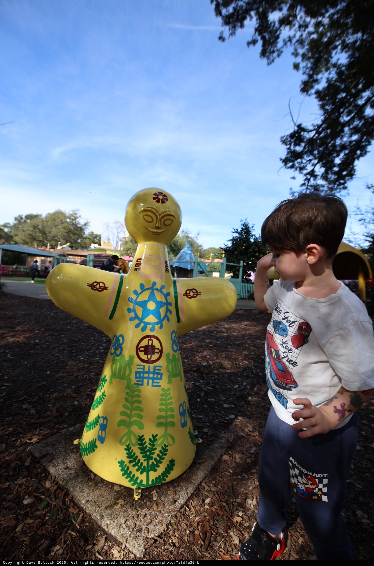 Young Boy Admiring Yellow Decorative Doll at Fantasyland