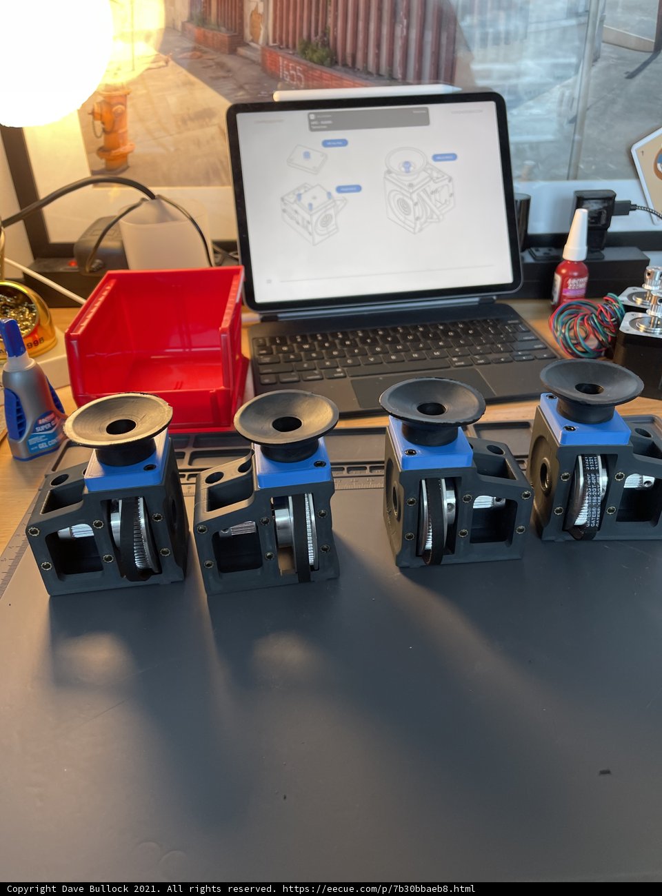 Four small machines on a table