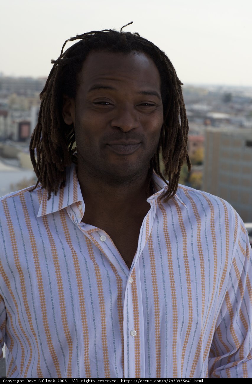 Dreadlocked Man Takes in the City