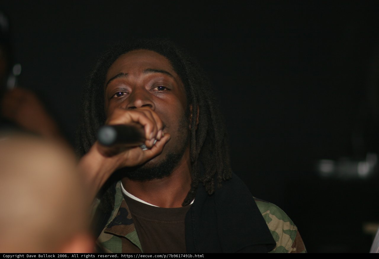 Dreadlocked Performer Takes Center Stage with Mic