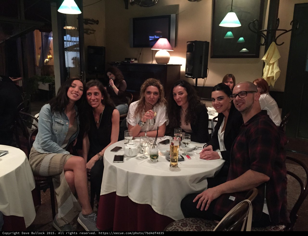 Friends Gathered Around Restaurant Table for Evening Drinks