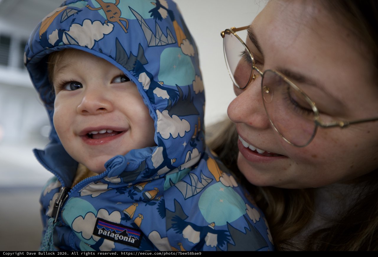 Joyful Winter Moment: Parent and Toddler Share a Smile