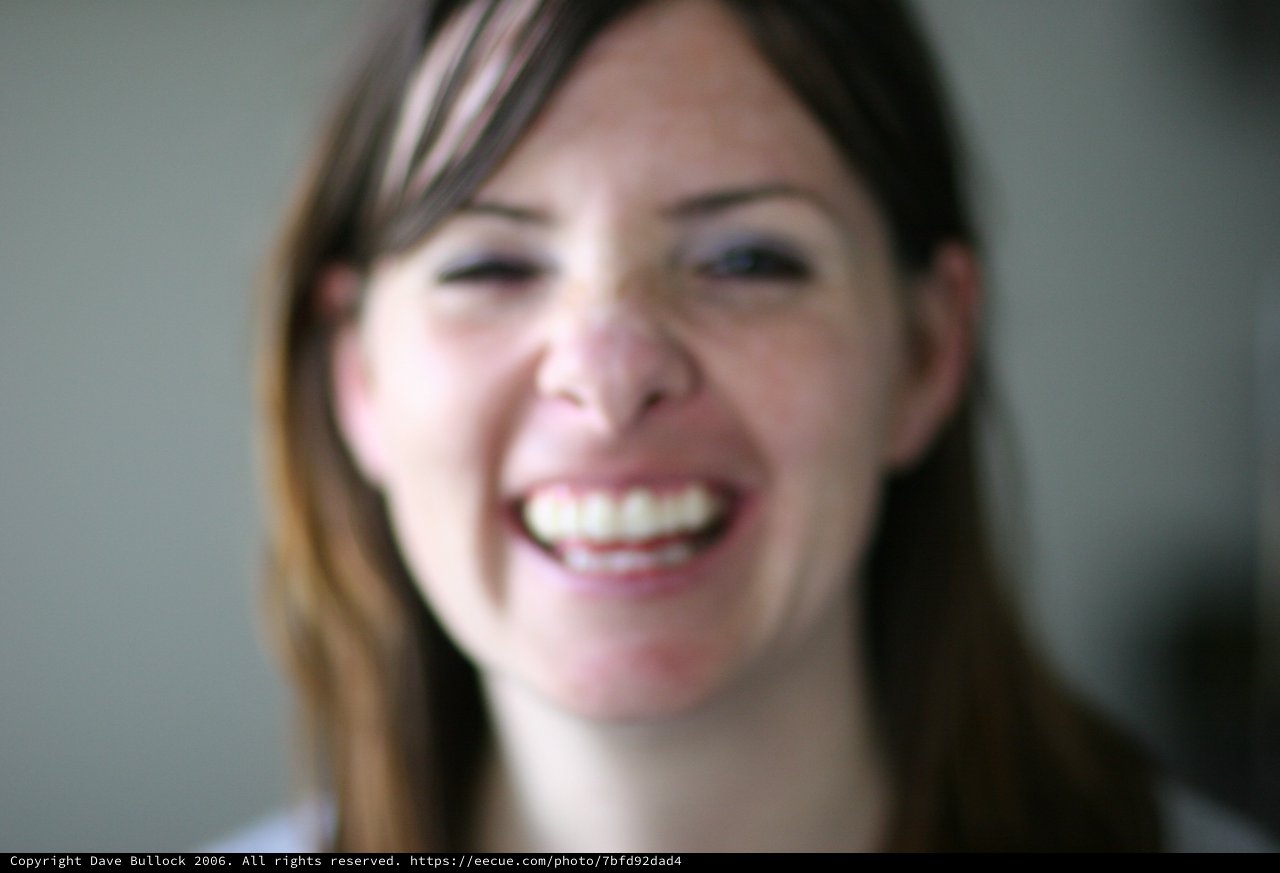 Joyful Woman Laughing in Soft Bokeh Portrait