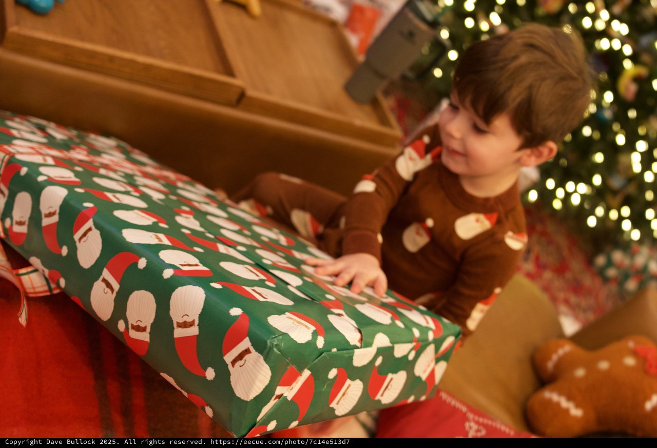 Christmas Morning Joy: Child Opening Festive Present