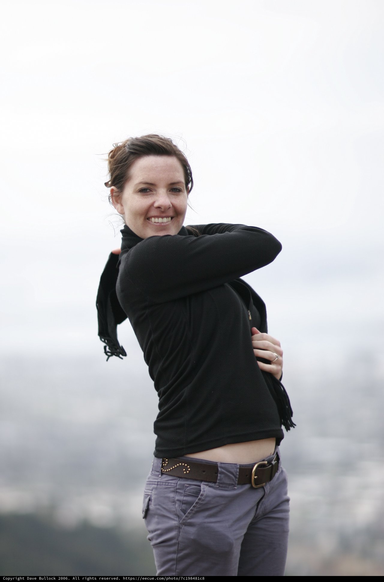 Windswept Woman Smiling Atop San Francisco Overlook