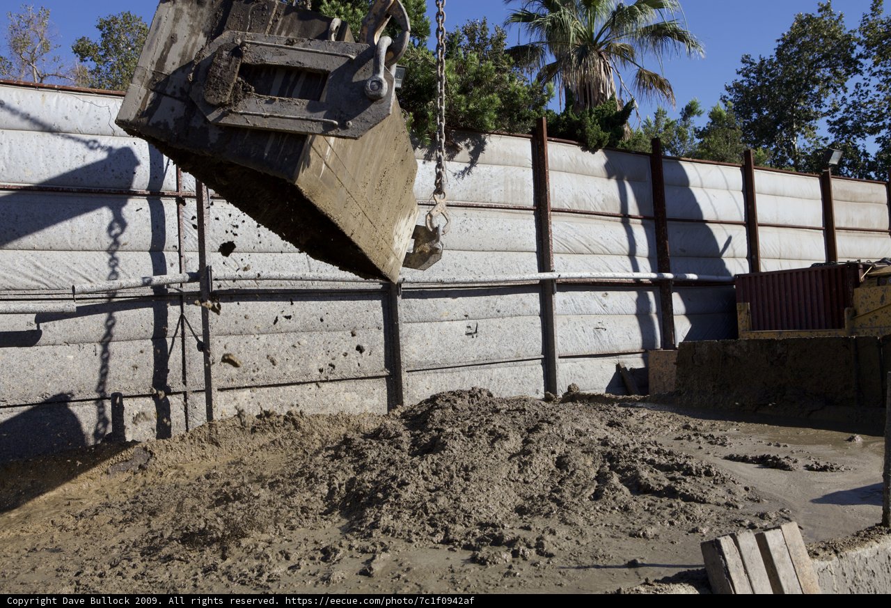 Dump Truck Unloading Soil into a Pile