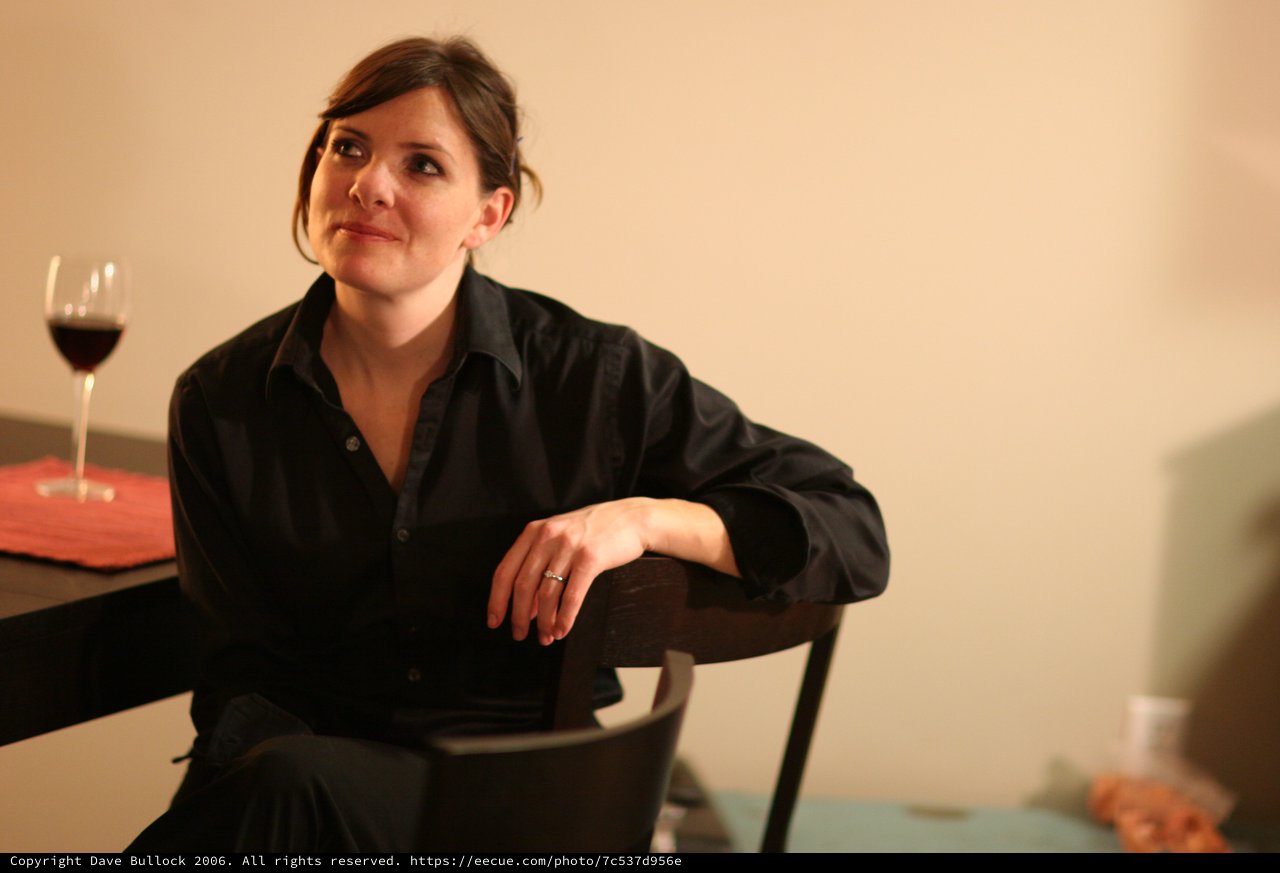 Thoughtful Woman in Black at Dinner Table