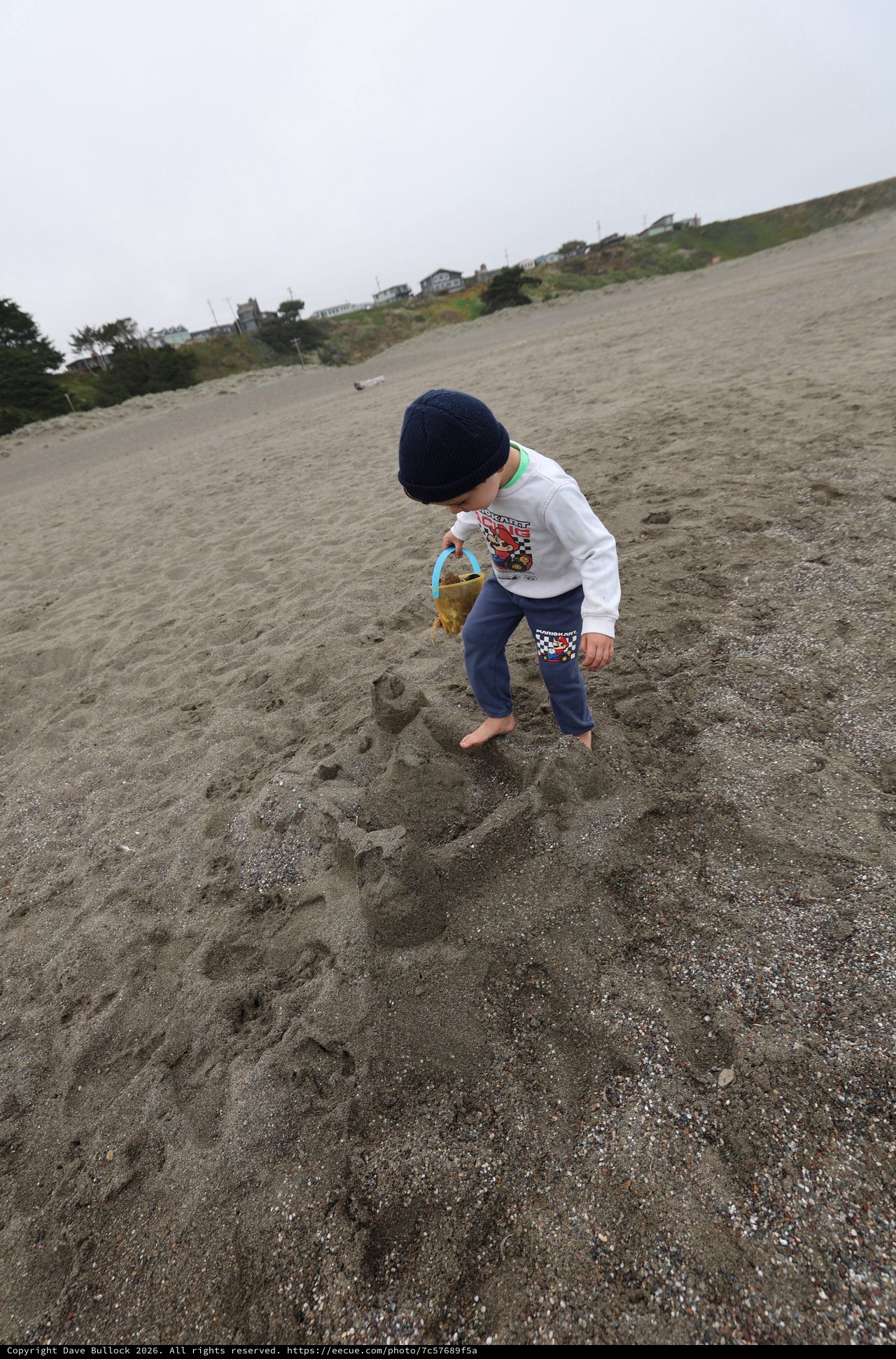 Young Boy Building Sandcastles on Foggy Beach