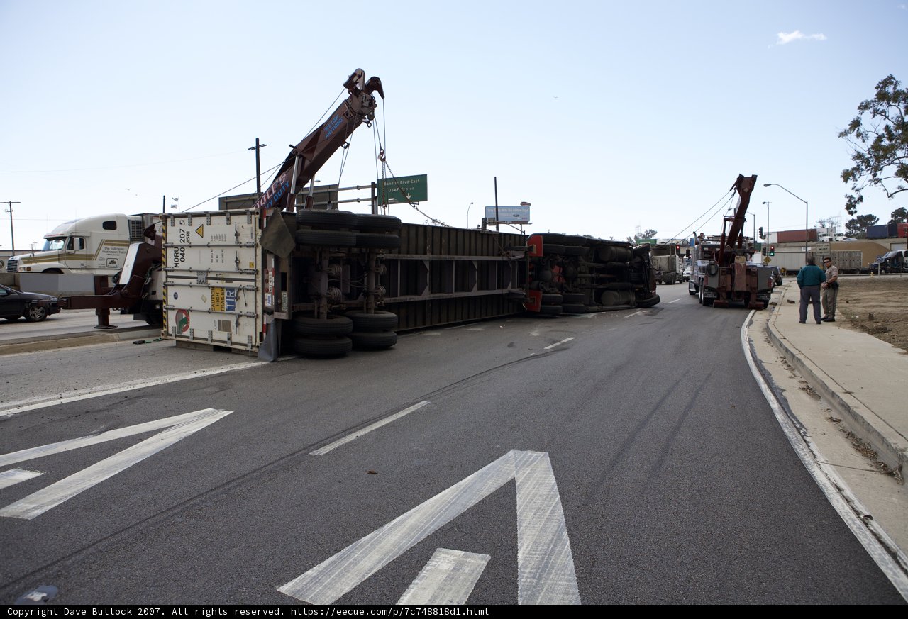 Crane Lifts Overturned Truck on Busy Street
