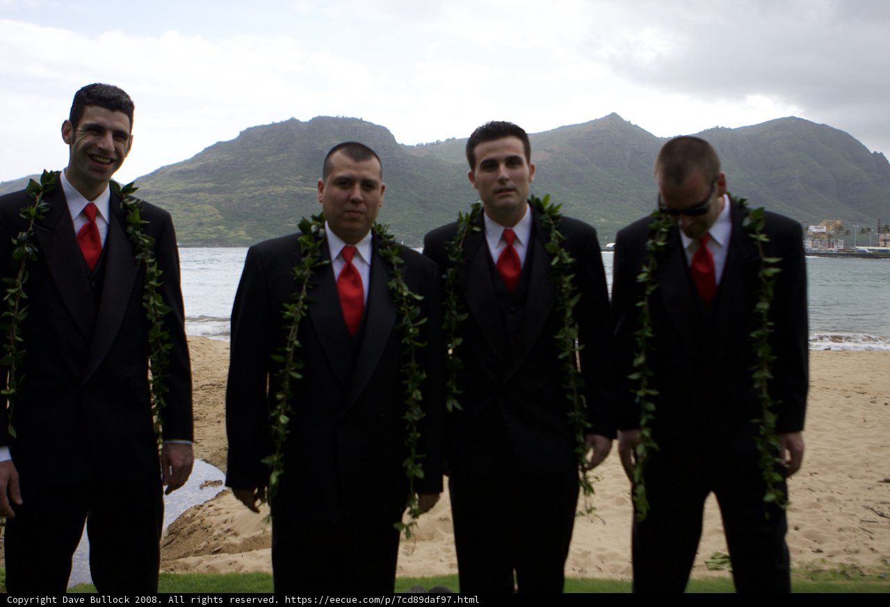 Four Men in Formal Wear on the Cloudy Beach