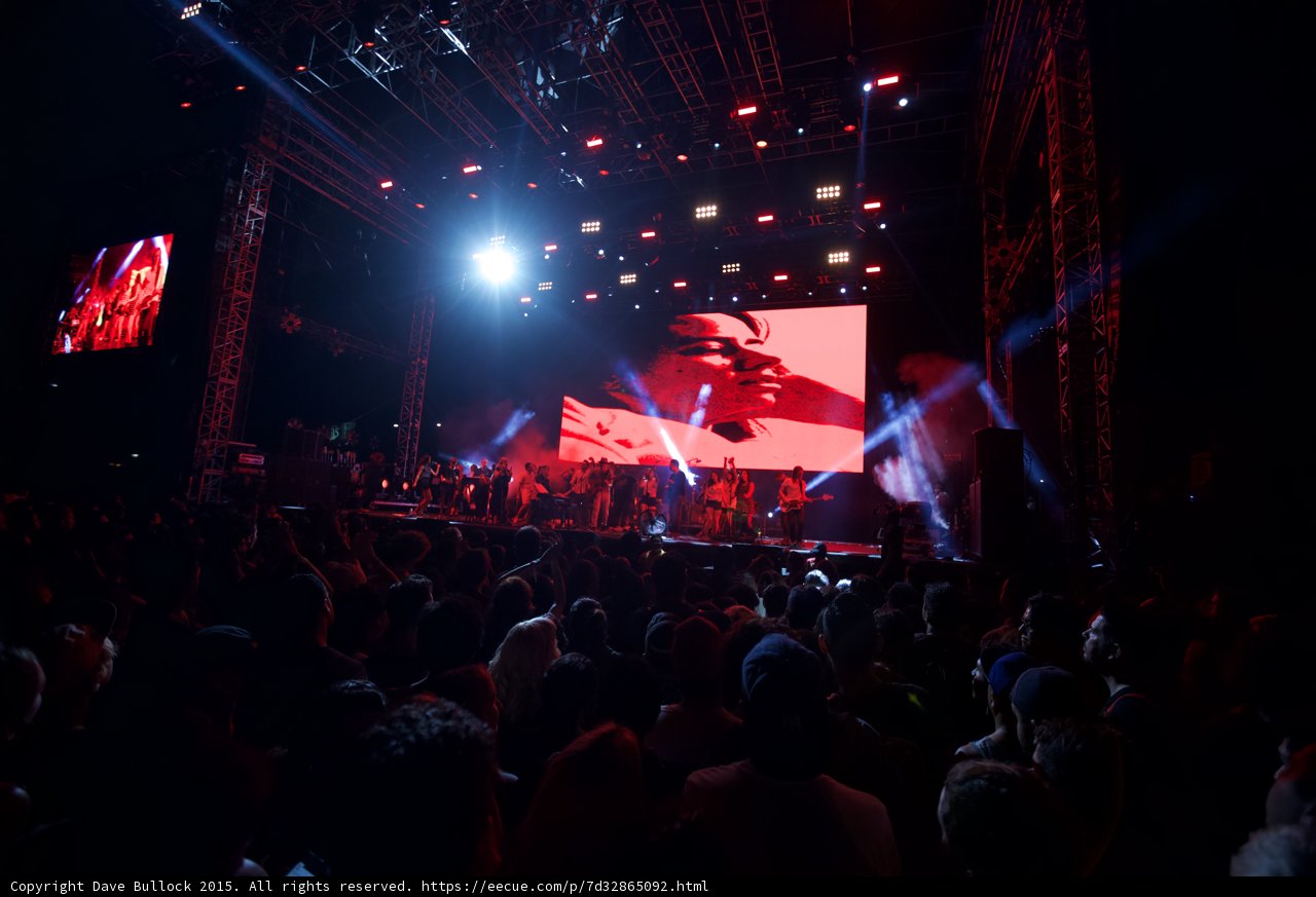 Belle and Sebastian Wide Stage Spotlight Flare Video Screen Romantic Red Lighting Ensemble Crowd
