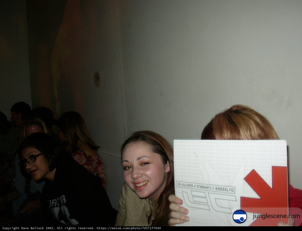 Woman holding up a sign in front of a group of people