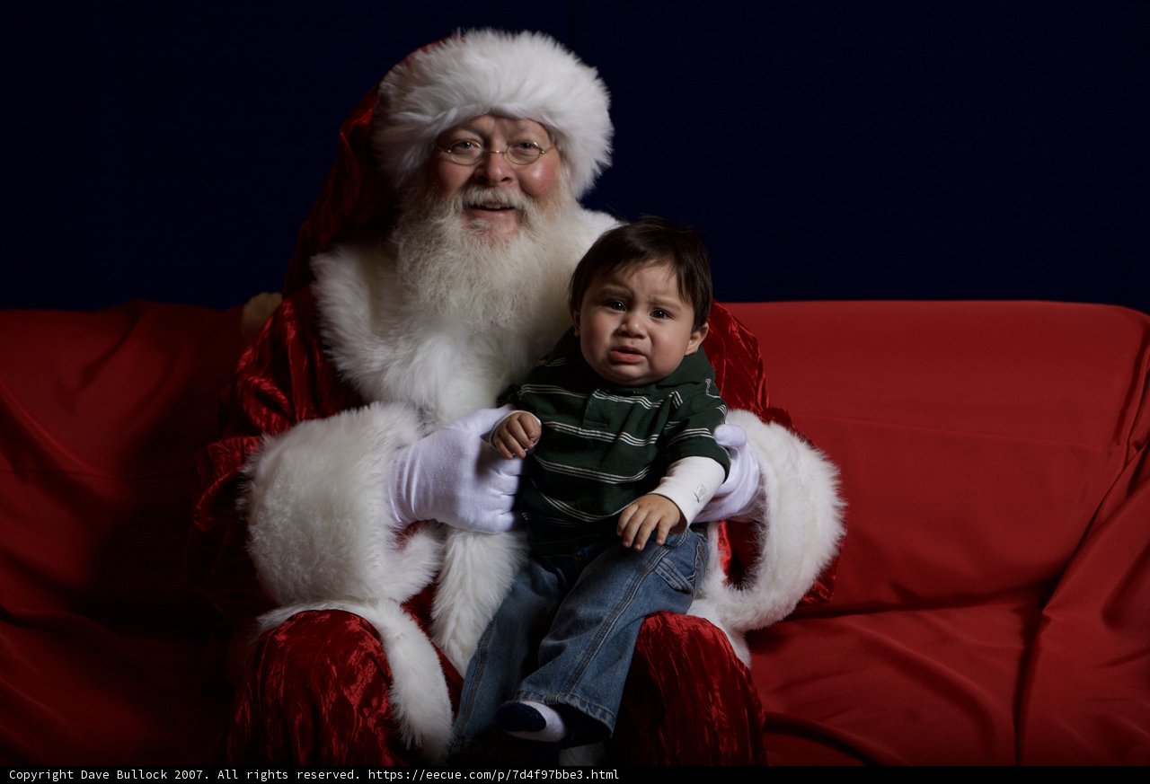 Santa Claus and Child on Festive Couch