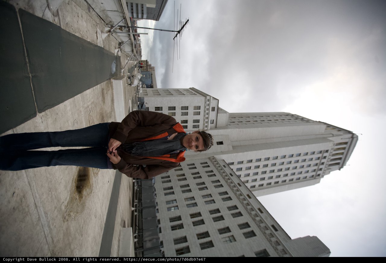 Woman Poses Atop Rooftop Before Los Angeles City Hall