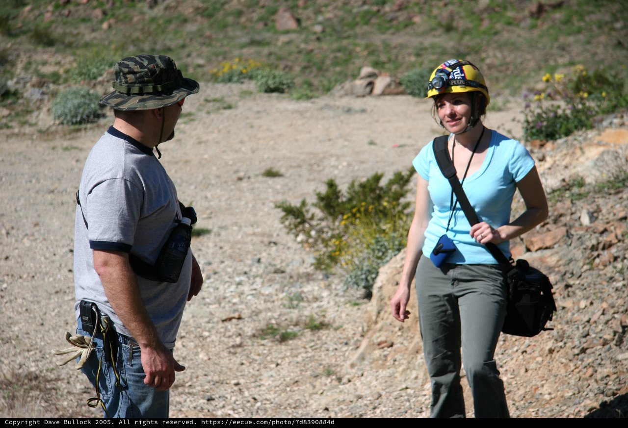 Adventure Duo Conversing on Rocky Desert Trail