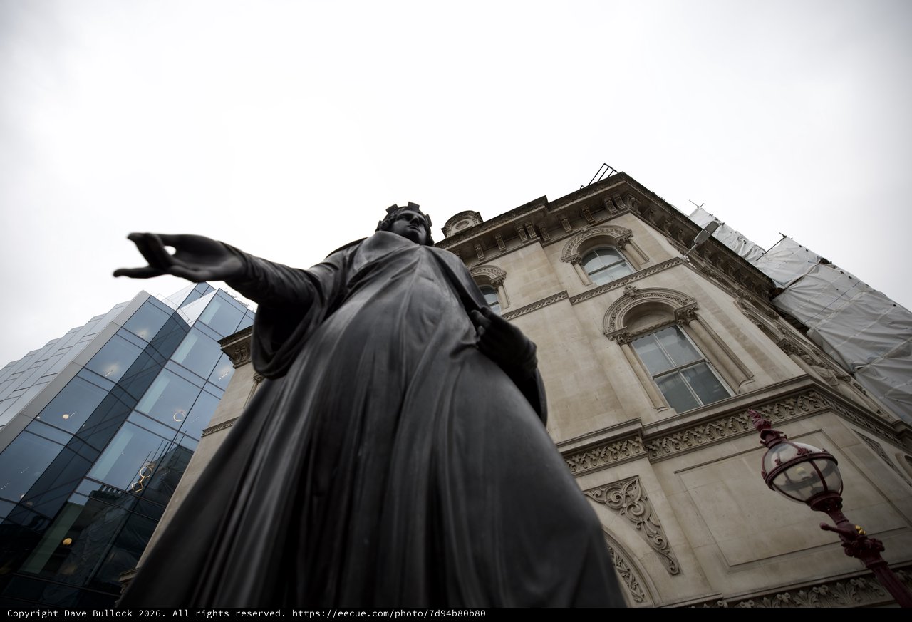 Monument Statue Pointing Forward Against Historic London Architecture