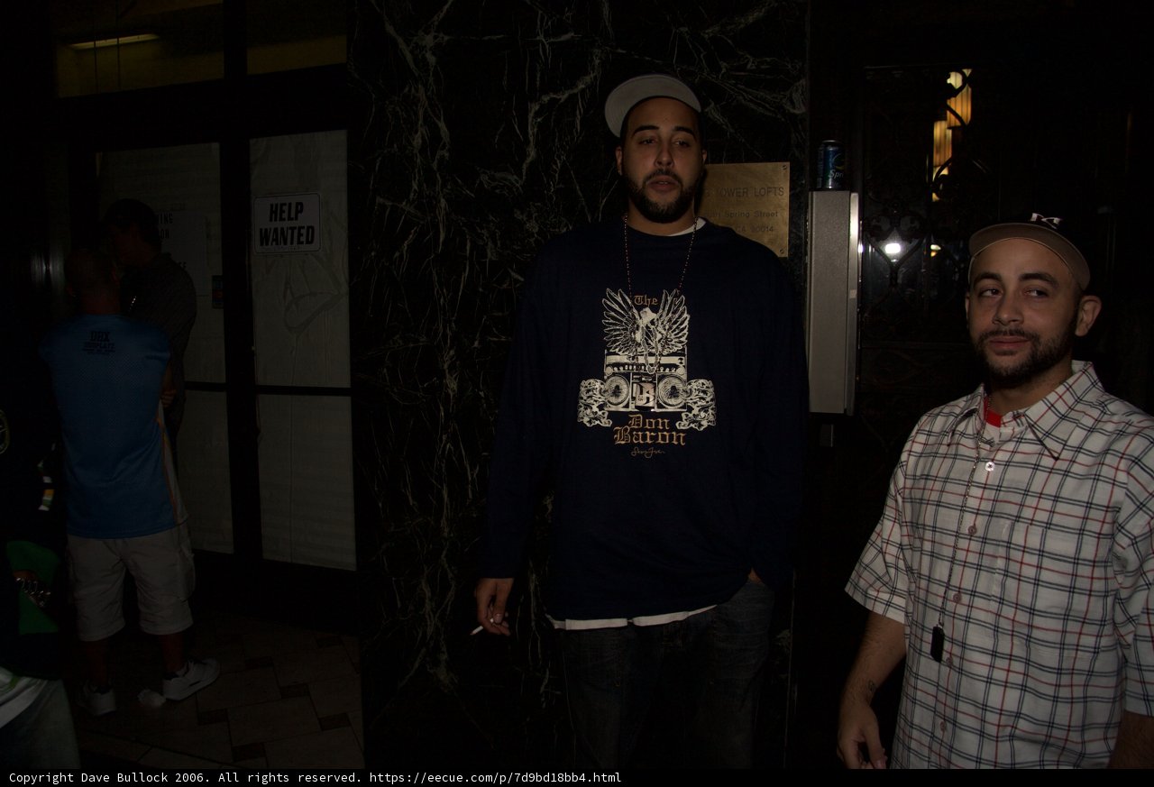Two Men Standing in Front of an Urban Building