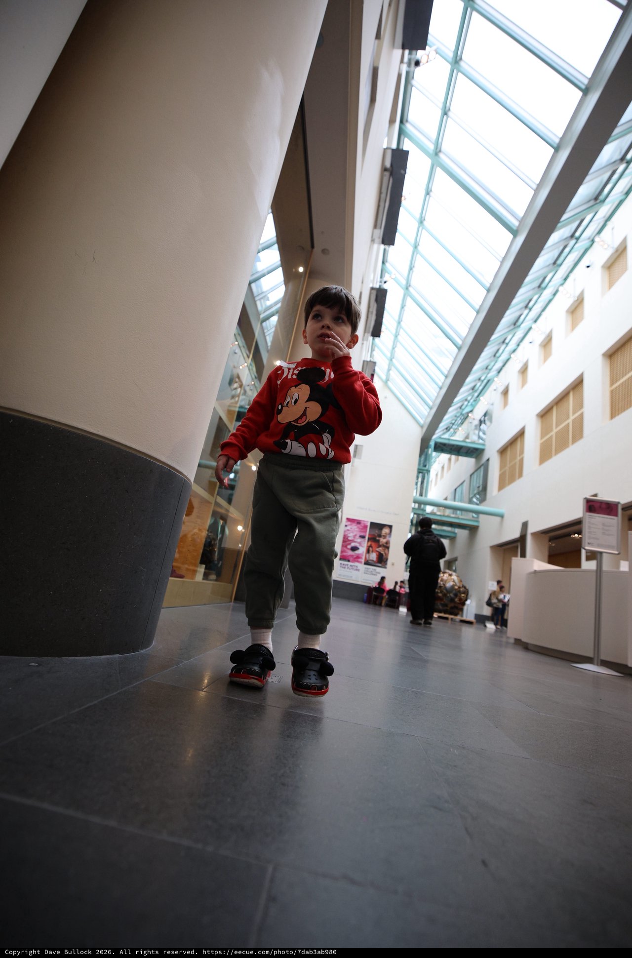 Young Child Exploring Modern Museum Atrium