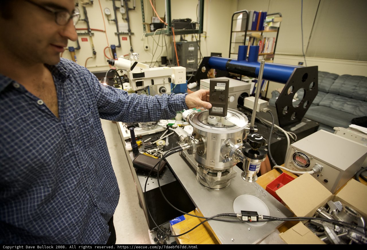 Lab Technician Holding Optical Testing Device