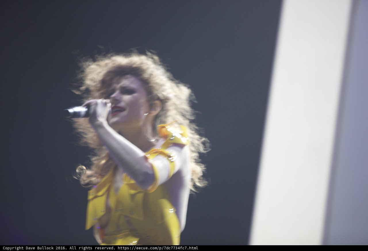 Yellow-Dressed Woman Entertains Crowd with Singing