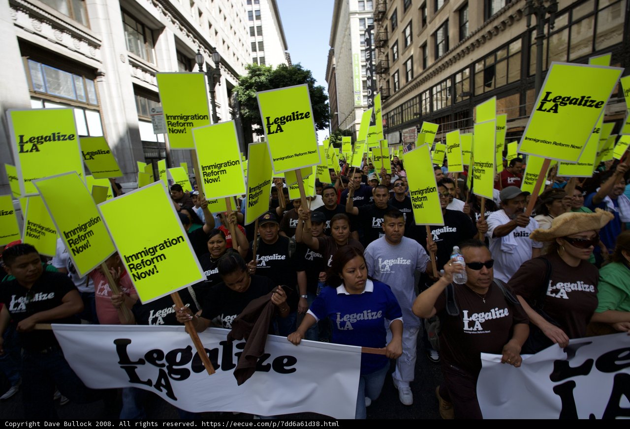 Mayday Protesters Hold Up Signs