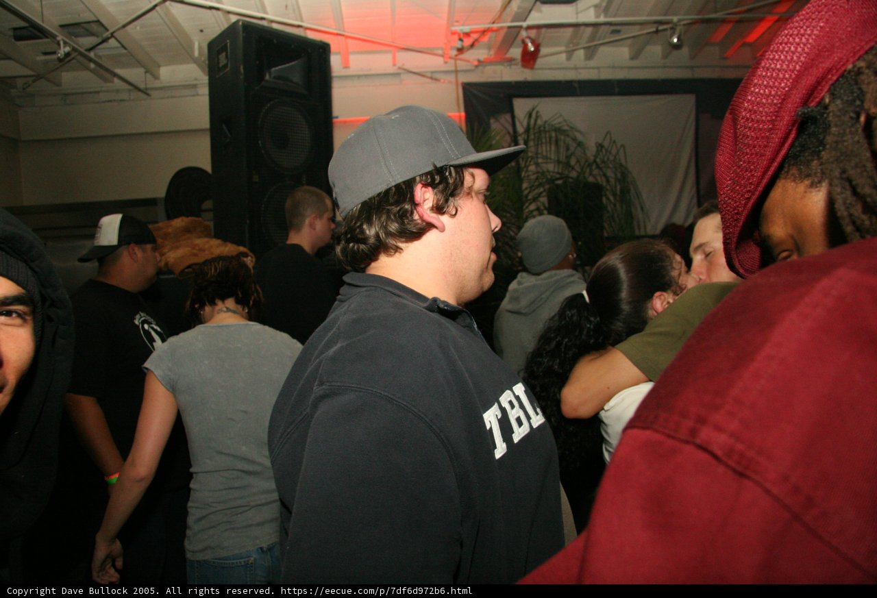 Hat-wearing Musician in a Crowded Urban Nightclub
