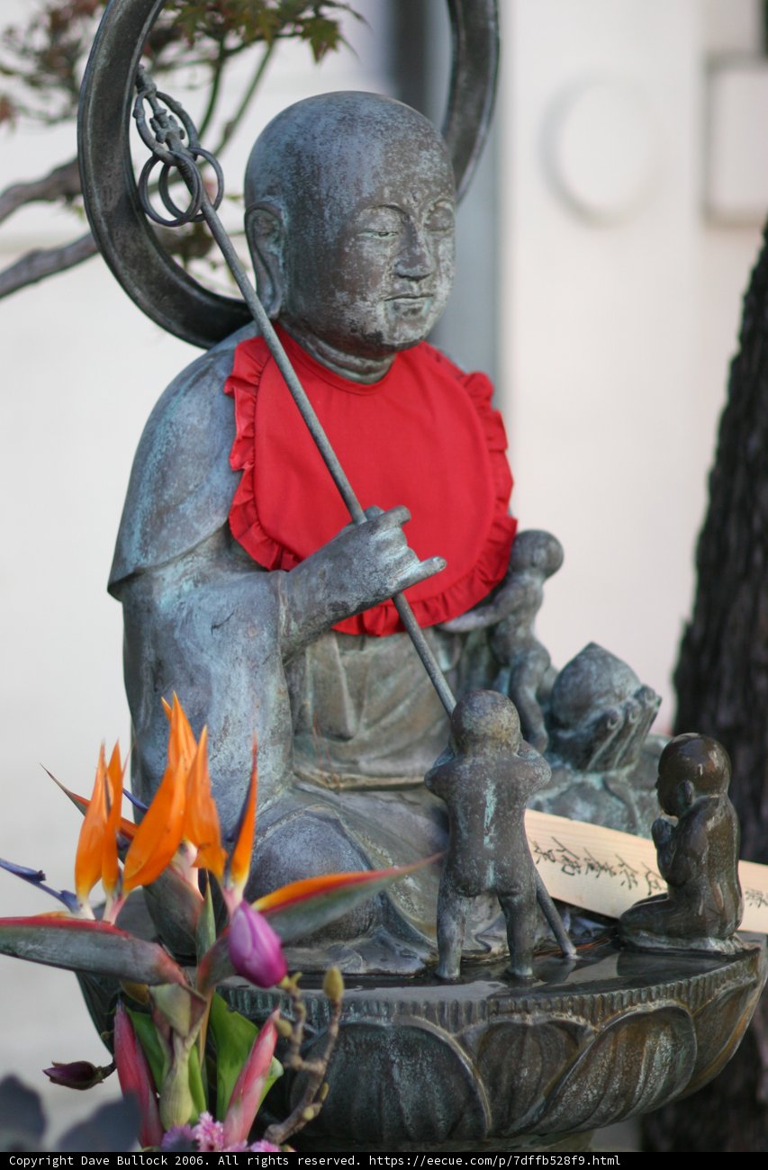 Buddha Statue Adorned with Flower Arrangements