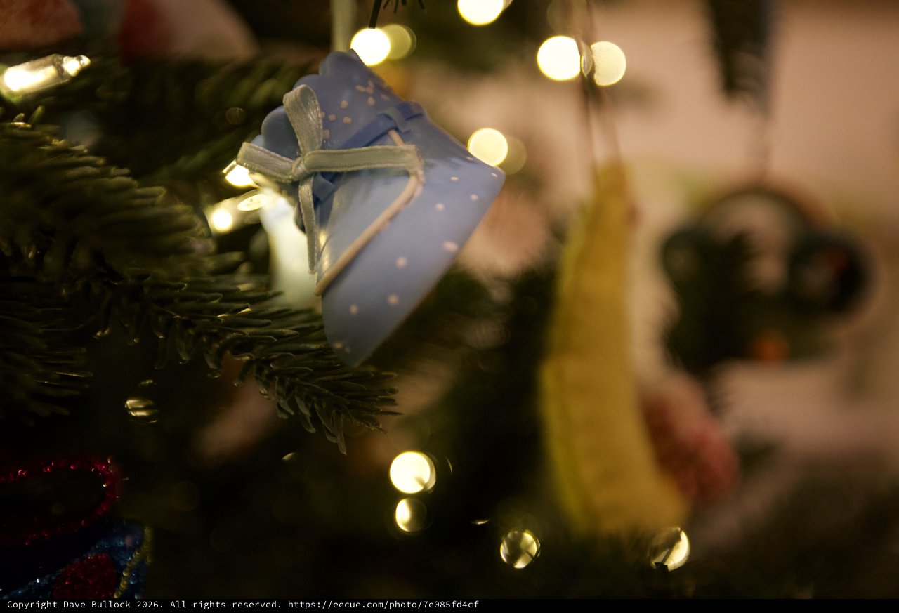 Blue Gift Ornament on Illuminated Christmas Tree
