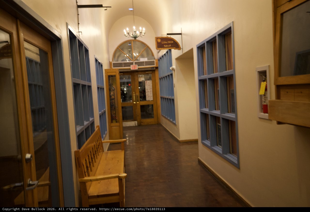 Historic School Hallway with Blue Lockers and Wooden Bench