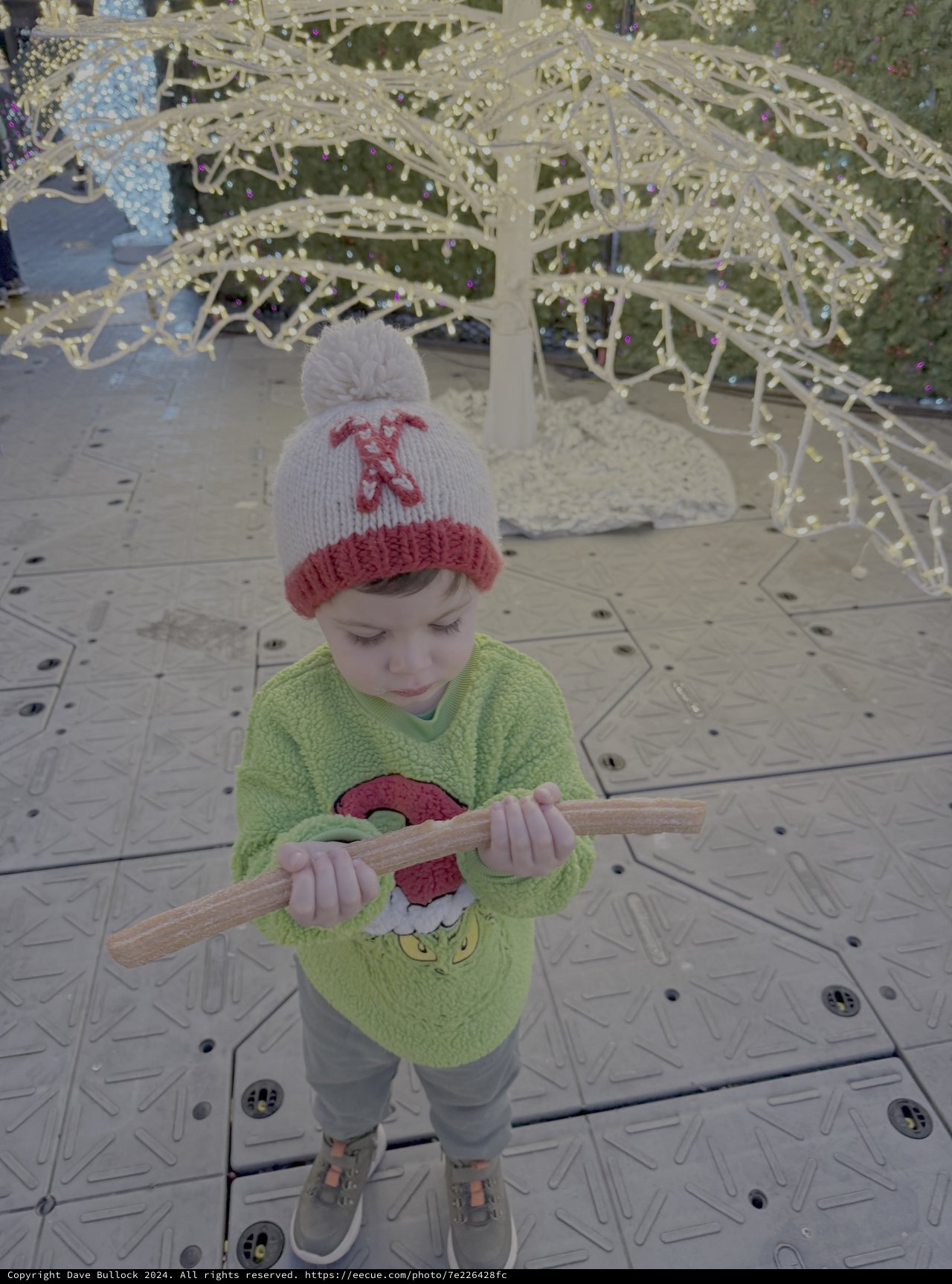 Child Playing with Wooden Stick at Winter Display
