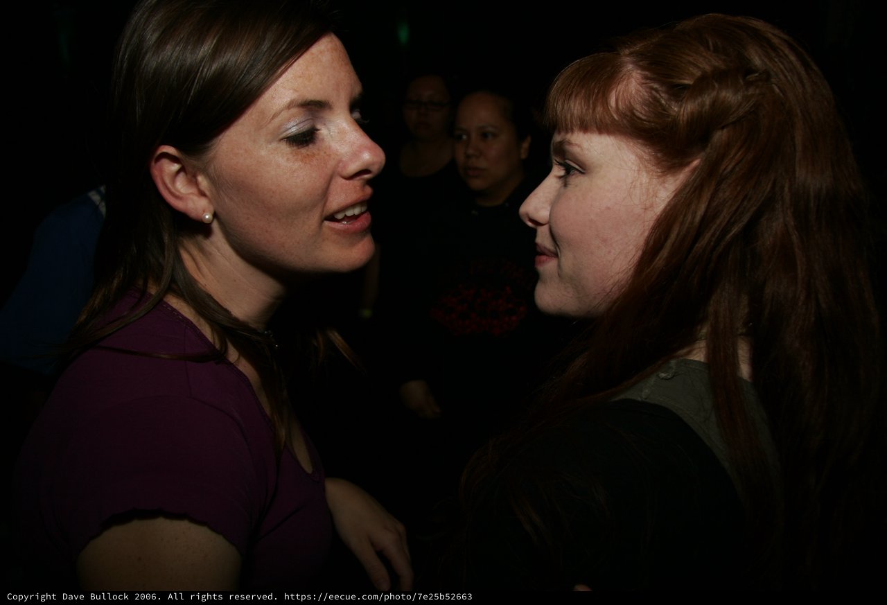 Two Women in Conversation at a Nightclub Event