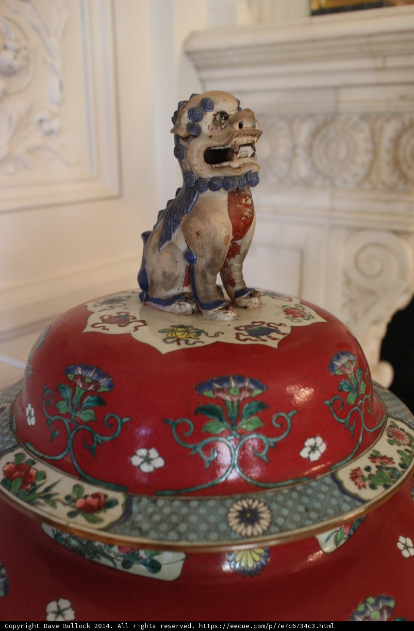 Ceramic Dog Figurine on Red and White Pottery Dish