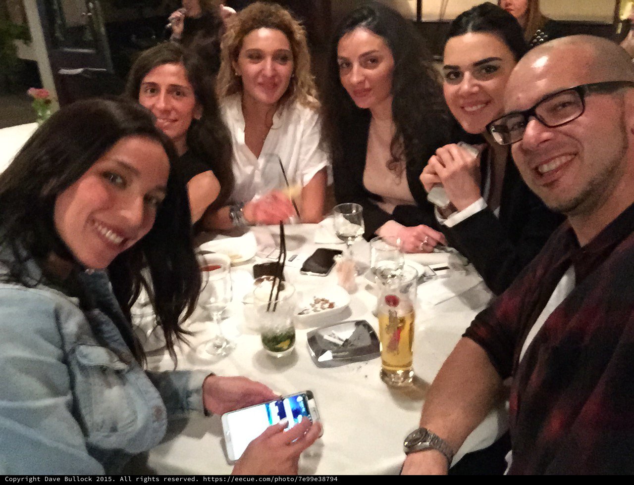 Friends Gathered Around Restaurant Table for Evening Dinner