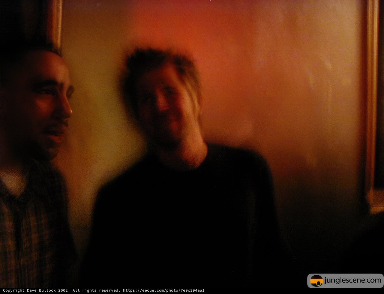 Two Men in a Dimly Lit Room