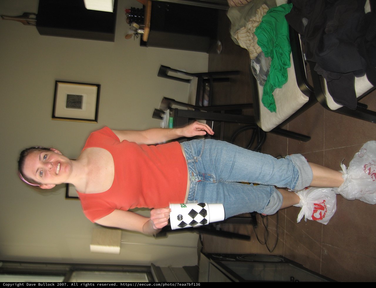 Smiling Woman with Bags on Feet in Apartment