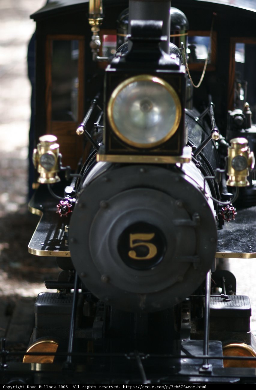 Black and Gold Locomotive Steaming Down the Tracks