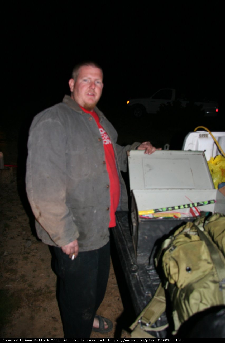 Man Standing Next to Truck with Box on It