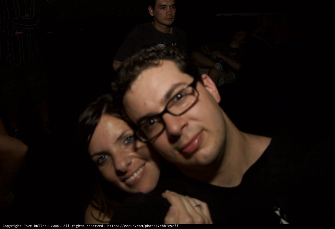 Friends Pose Close Together at Nighttime Event