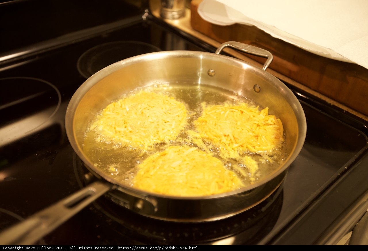 Three eggs sizzling on the stove