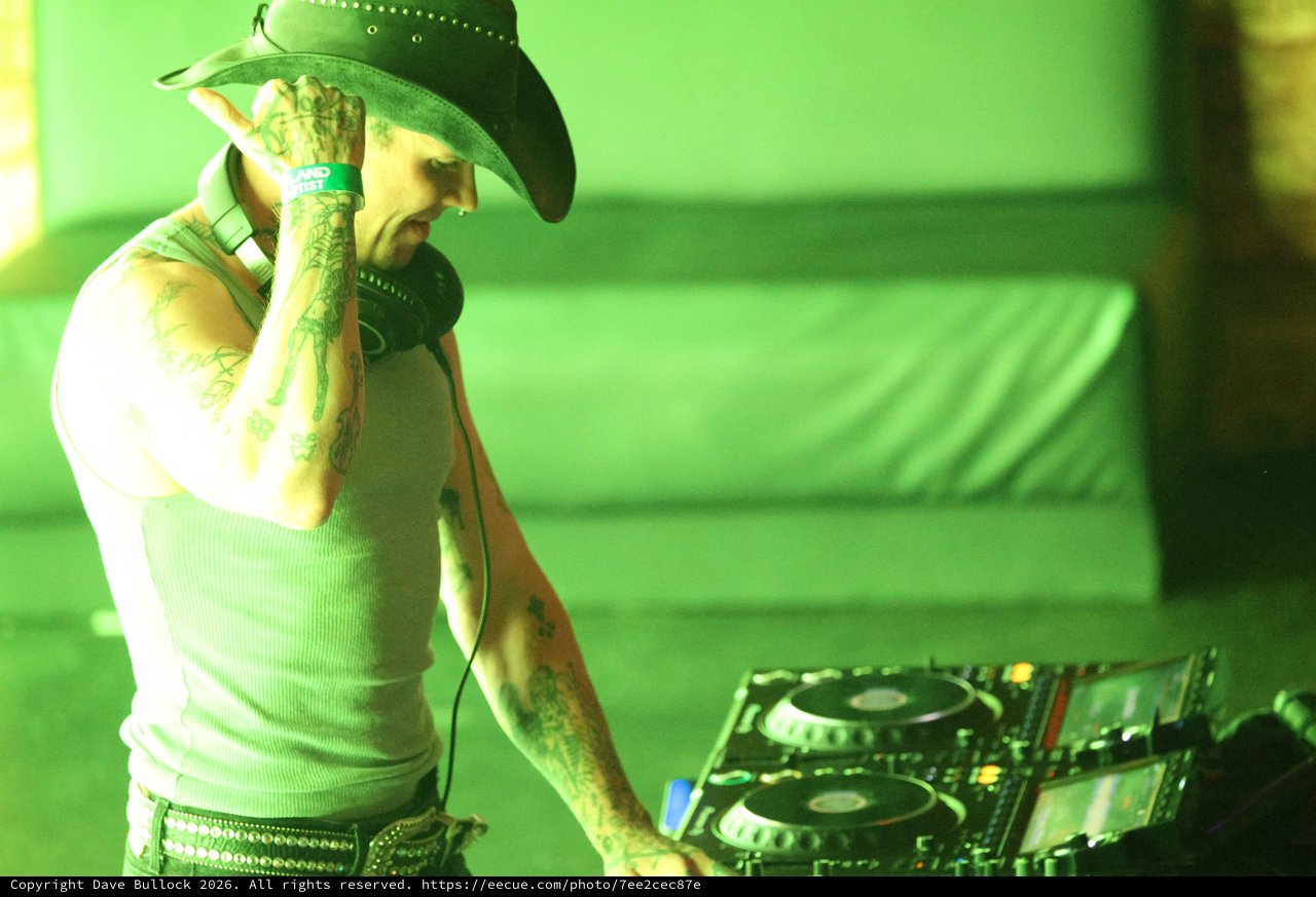 Tattooed DJ Performs Under Green Lights at Wobbleland