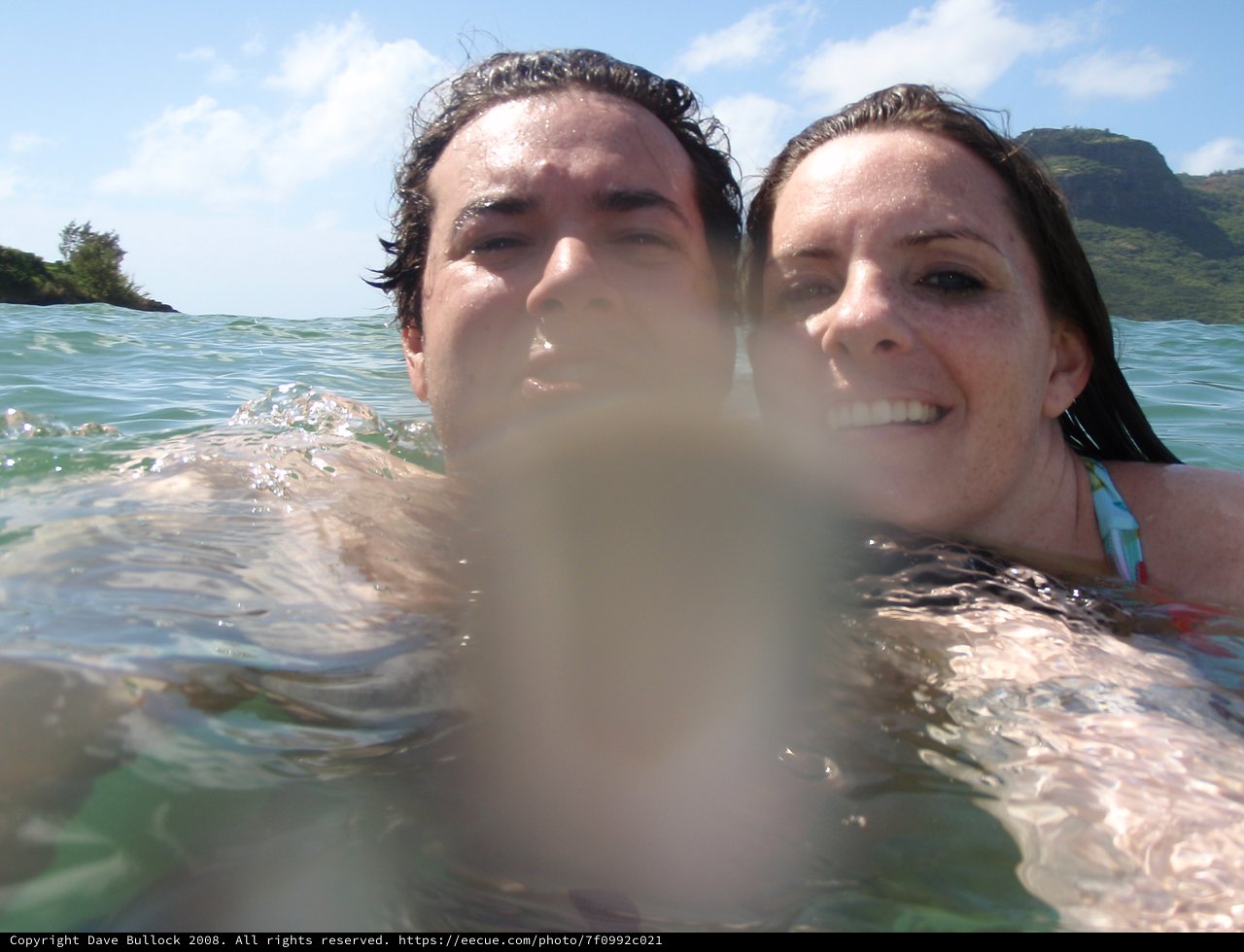 Couple Swimming in Hawaiian Ocean Waters Together