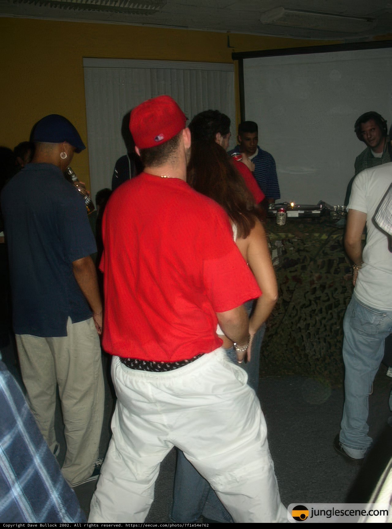A Group of People Surrounding a Man in a Red Shirt