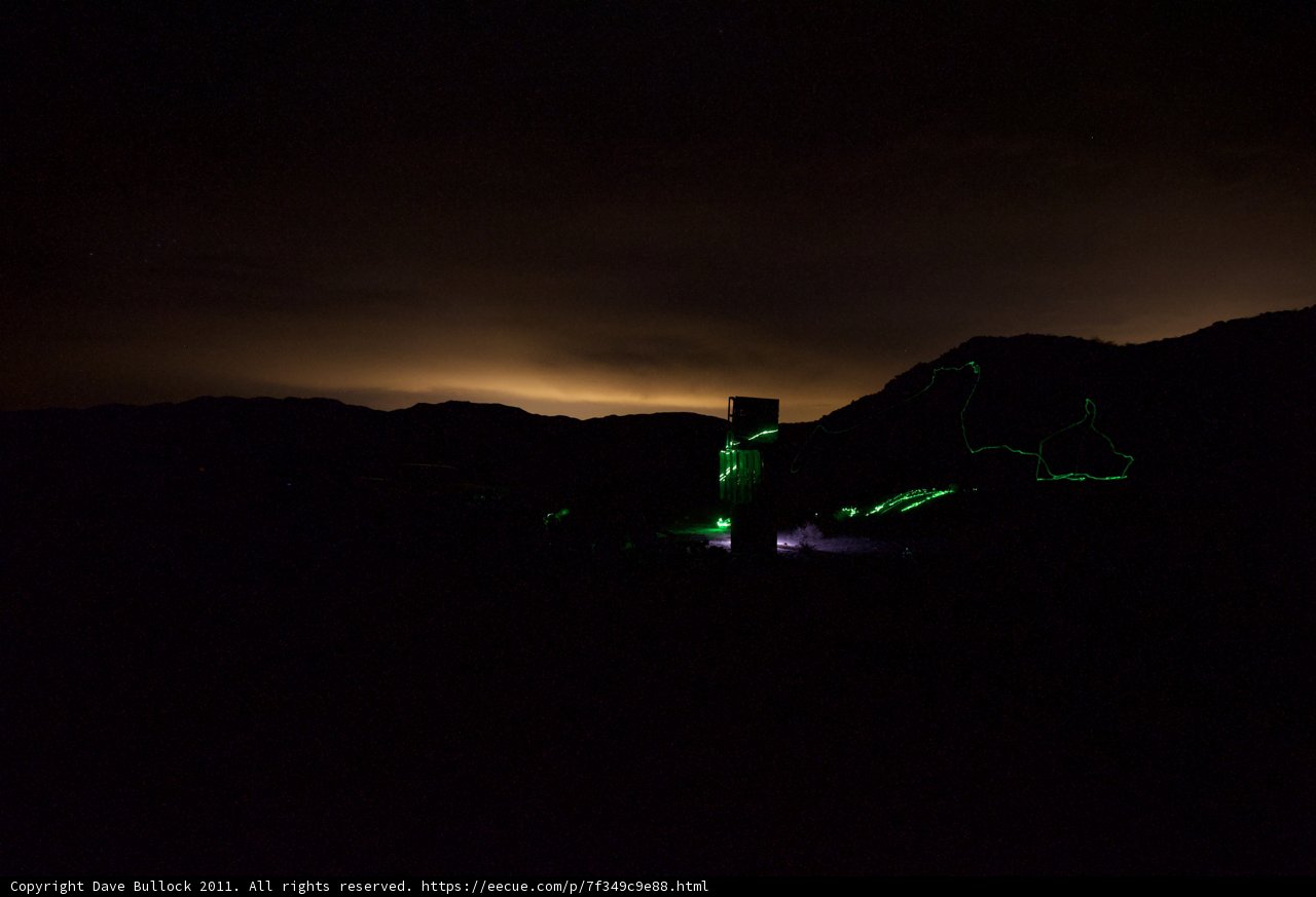 A Green Laser Illuminating a Mountain at Night