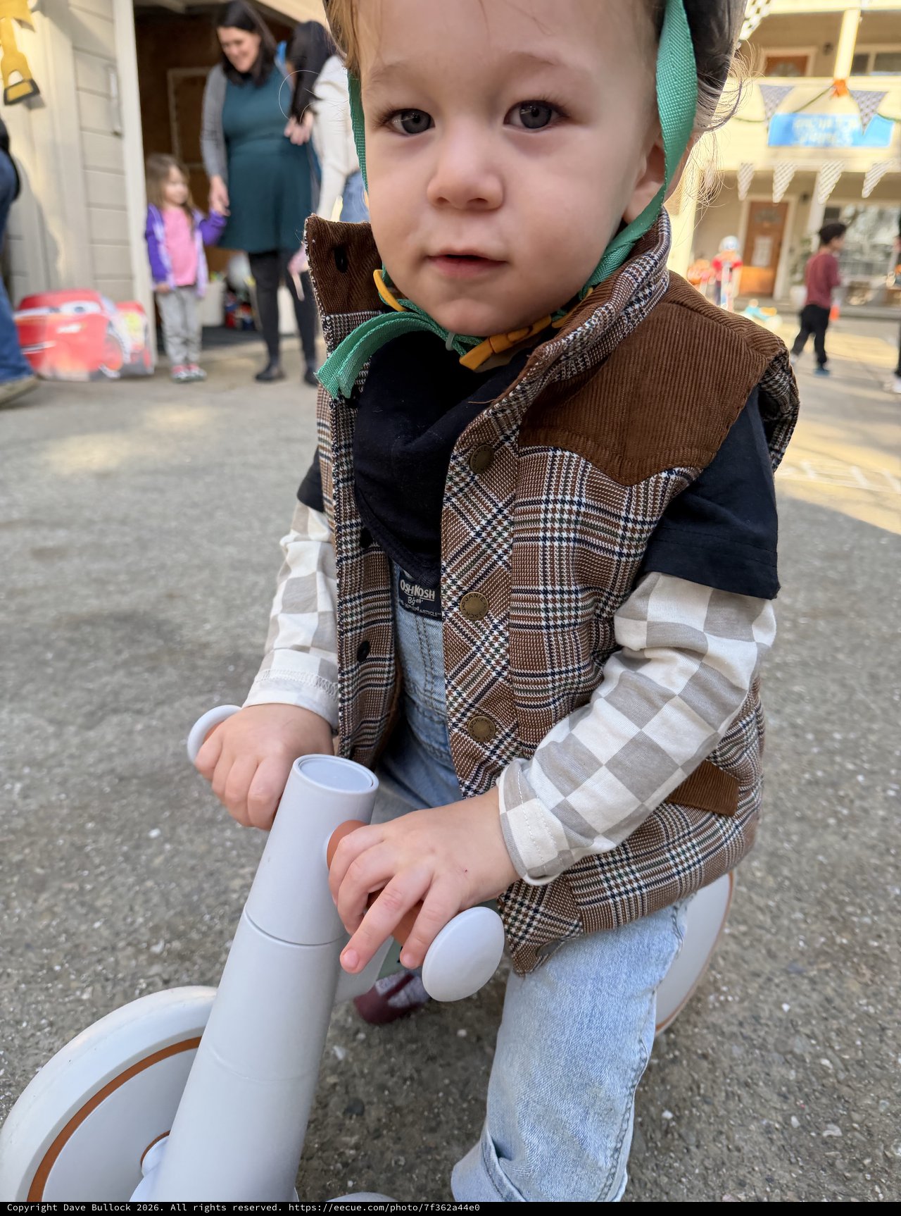 Toddler on Toy Bike at Community Event