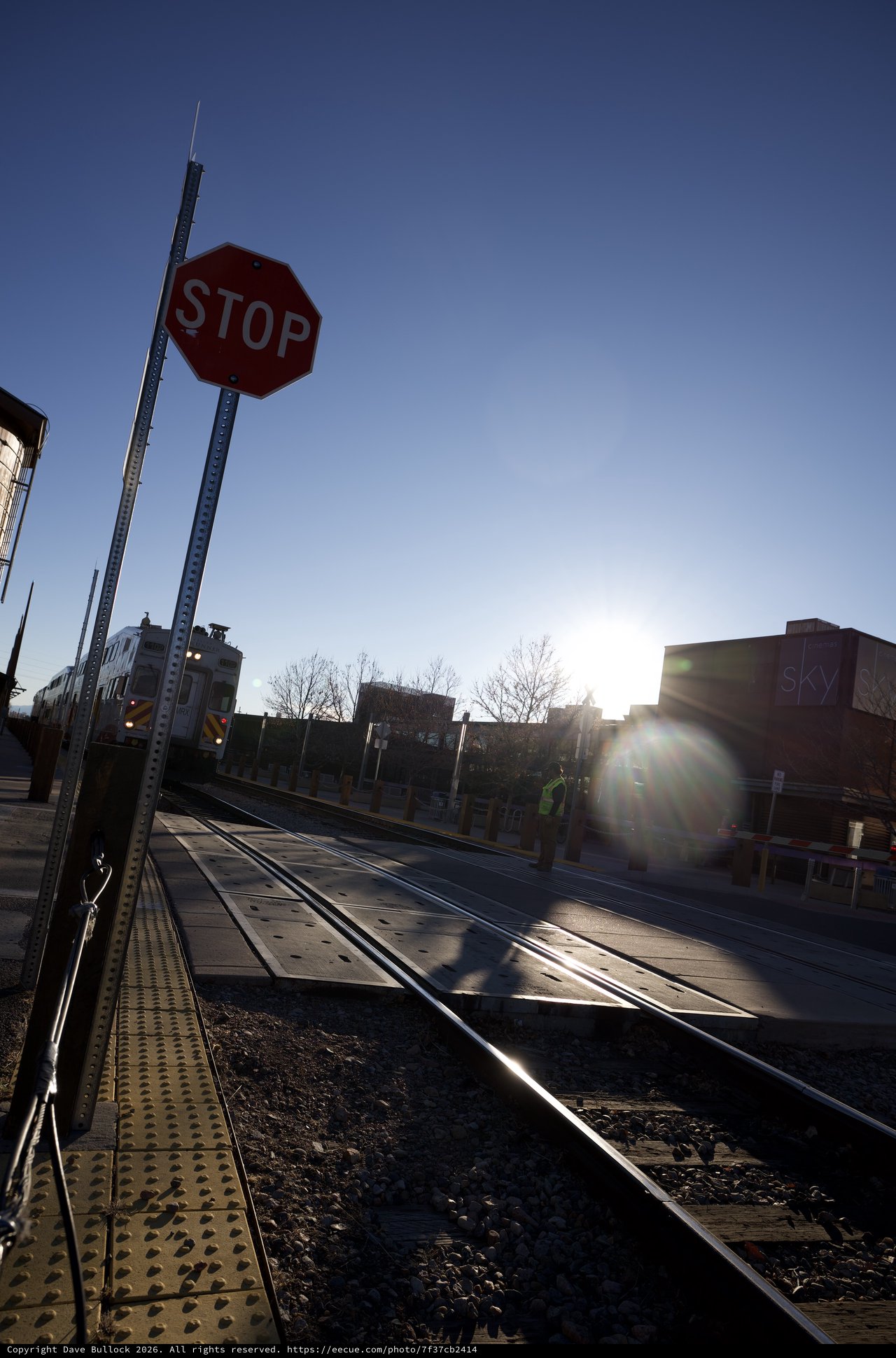 Railroad Crossing at Sunset with Stop Sign