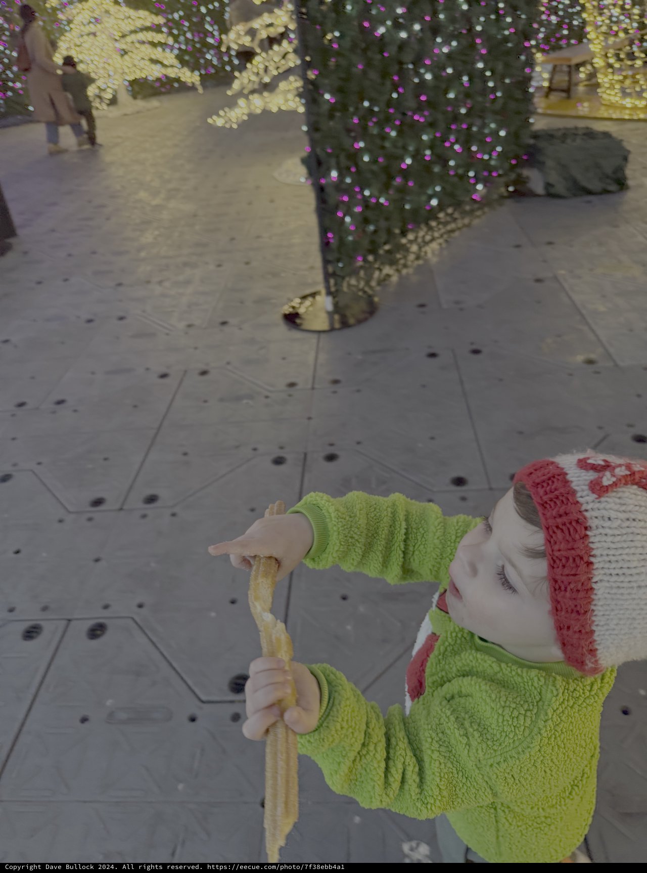 Child Enjoys Sweet Treat at Holiday Market