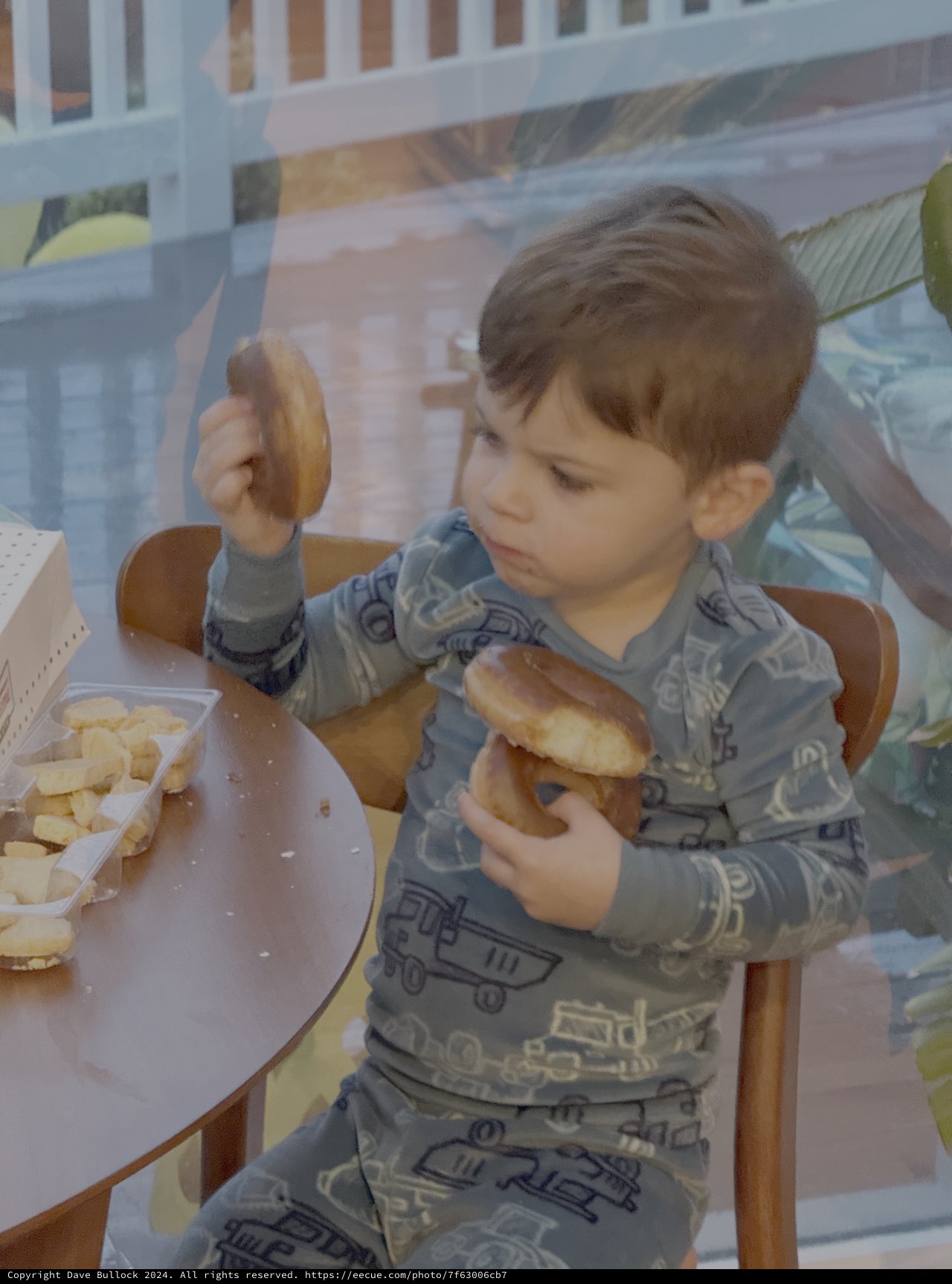 Toddler Enjoying Donuts at Breakfast Table