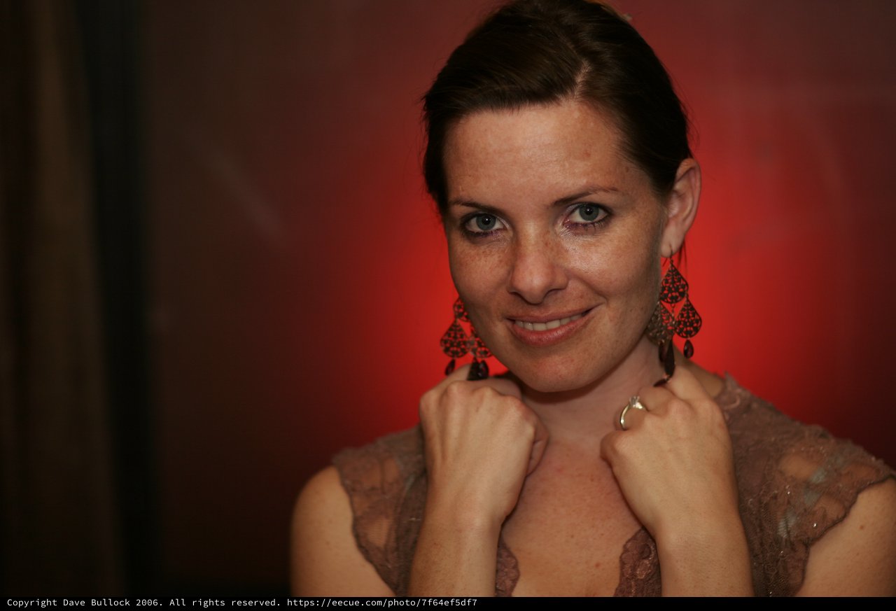 Penelope in Red: Elegant Portrait with Chandelier Earrings