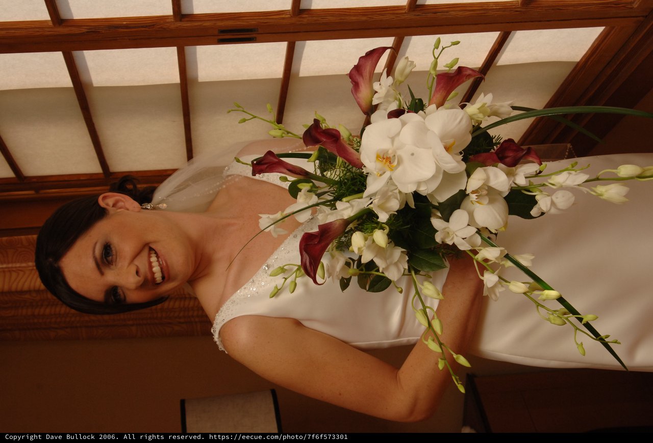 Radiant Bride Holding Elegant Wedding Bouquet Indoors